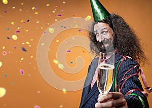 Portrait of an elegant skinny guy holding a glass of champagne