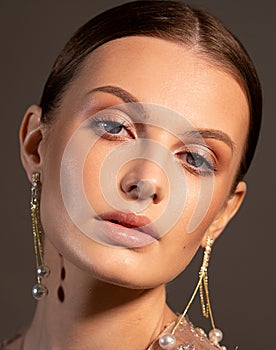 Portrait of an elegant woman. The hair is slicked back smoothly.