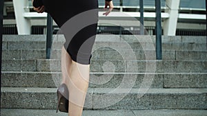 Portrait elegant woman legs going upstairs in stylish shoes outdoors