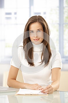 Portrait of elegant woman taking notes