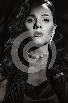 Portrait of an elegant woman in vintage retro style of black and white Hollywood movies with makeup and hairstyle.