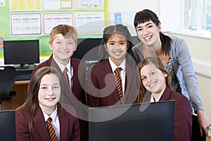 Portrait Of Elementary School Pupils With Teacher In Computer Cl