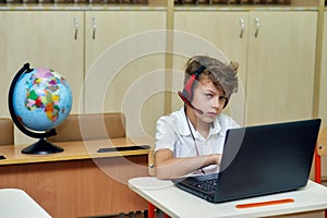Portrait of an elementary school student in the classroom with a laptop