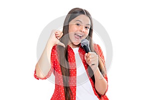 Portrait of emotional amazed excited teen girl with microphone singing against white background. Singing lovely singer