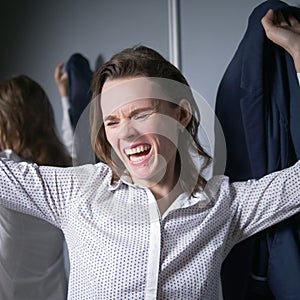 portrait of an emotional business woman taking off her jacket, smiling happily