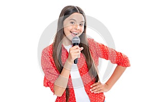 Portrait of emotional excited teen girl with microphone singing against white background. Singing lovely singer girl