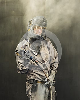 Portrait of an employee of the car body painting shop in protective clothing