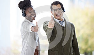 Portrait, employee and happy with thumbs up at call center for customer or client support and service. Office, crm and