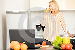 Woman using laptop in the kitchen