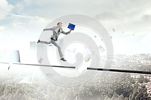 Portrait of energetic businessman jumping in open air