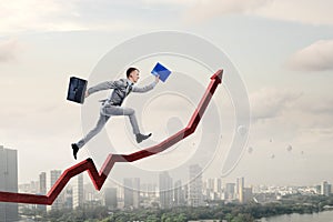 Portrait of energetic businessman jumping in open air