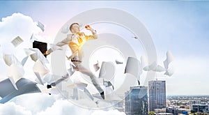 Portrait of energetic businessman jumping in open air