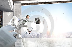 Portrait of energetic businessman jumping in open air