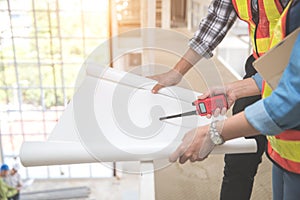 Portrait engineer people looking and checking work at construction site with blueprint