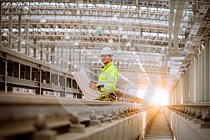 Portrait engineer under inspection and checking construction process railway and checking work on railroad station .Engineer weari