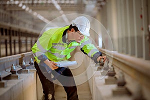 Portrait engineer under inspection and checking construction process railway and checking work on railroad station .Engineer weari