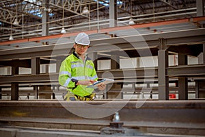 Portrait engineer under inspection and checking construction process railway and checking work on railroad station .Engineer weari