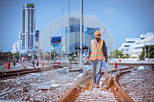 Portrait engineer under inspection and checking construction process railway switch and checking work on railroad station .Enginee