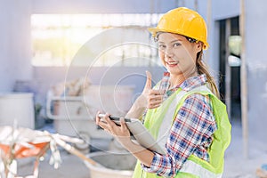 Portrait engineer woman worker as builder project manager inspector happy smile thumbs up with tablet