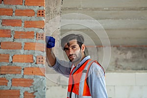 Portrait Engineer working hard at a construction site. Working way in hot weather. Career work hard