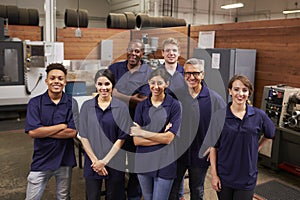 Portrait Of Engineers And Apprentices In Busy Factory