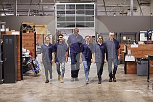 Portrait Of Engineers And Apprentices In Busy Factory