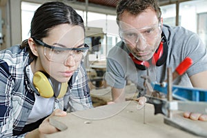 portrait engineers working on factory machine