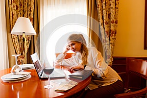 Portrait of european business woman paying bills online with laptop in office. Beautiful girl with computer and