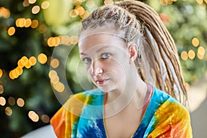 Portrait of european woman 28 years old with dreadlock african braids indoors.