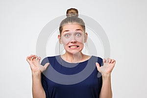 Portrait of european woman with baun hairstyle with shocked face. Expression emotion and feelings concept. photo