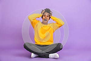 Portrait of excited african american boy screaming and grabbing