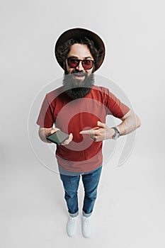 Portrait of excited bearded man holding smartphone