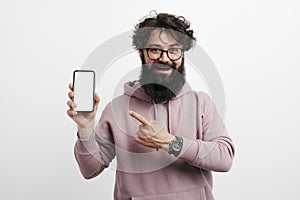 Portrait of excited bearded man holding smartphone