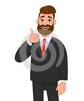 Portrait of excited business man dressed in black formal wear showing thumbs up sign. Deal, like, agree, approve, accept. photo
