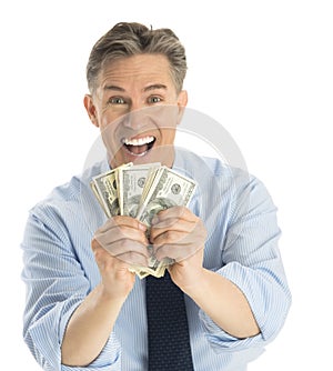 Portrait Of Excited Businessman Showing Dollar Bills
