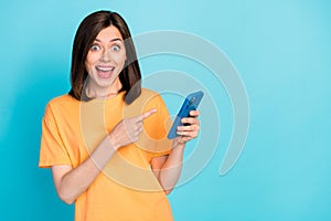 Portrait of excited cheerful person direct finger telephone instagram facebook whatsup isolated on blue color background photo