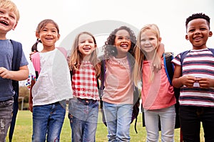 Portrait Of Excited Elementary School Pupils On Playing Field At Break Time