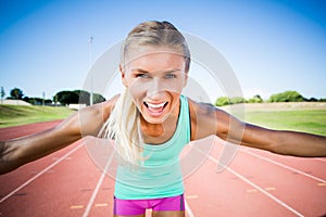 Portrait of excited female athlete posing after a victory