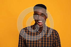 Portrait Of Excited Funny Black Guy Looking At Camera With Amazement