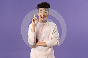 Portrait of excited happy man finally understood something, have great idea, express suggestion or opinion, raise finger