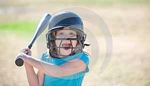 Portrait of excited kid baseball player wearing helmet and hold baseball bat.