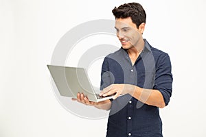 Portrait of an excited man holding laptop computer