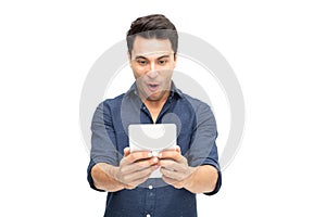 Portrait of an excited man playing games on tablet isolated over white background.