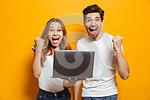 Portrait of excited man and woman screaming and clenching fists