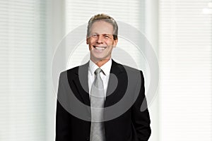 Portrait of excited mature businessman.