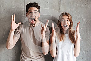 Portrait of excited people man and woman in basic clothing shout