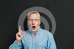 Portrait of excited retired man 60s with grey hair and beard in