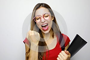 Portrait of excited smiling female student celebrating success isolated over white background