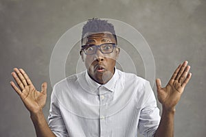 Portrait of excited surprised black man looking at camera with shocked face expression