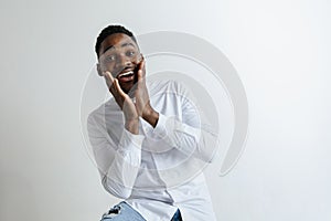 Portrait of excited young African American male screaming in shock and amazement.